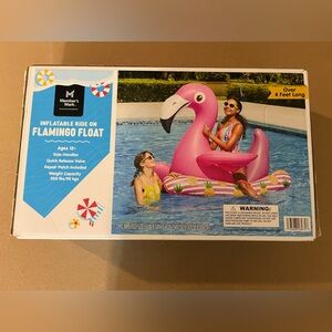 Members mark giant flamingo ride on float.